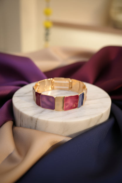 Gold bracelet with purple and red square stones